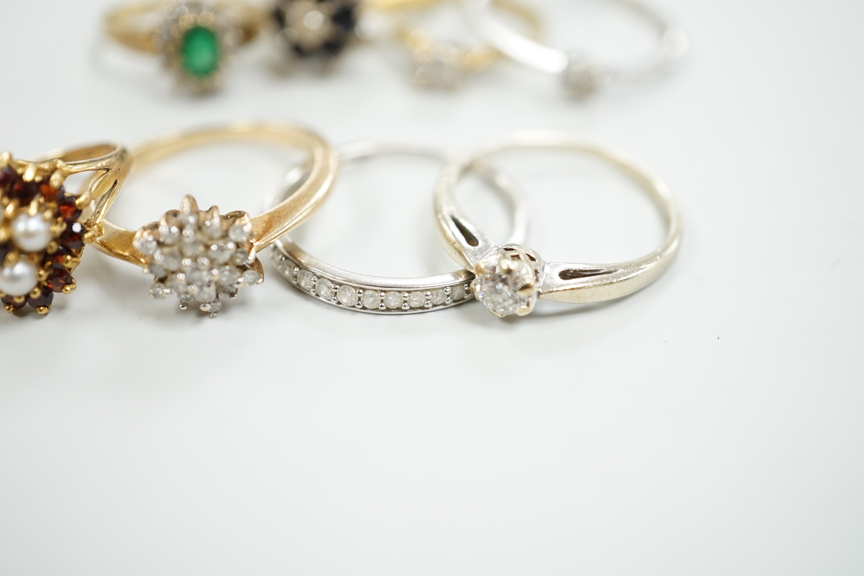 Eight assorted mainly modern 9ct gold and gem set rings, including solitaire diamond and diamond chip half eternity, gross weight 18.8 grams.